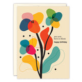 The You Were Born To Bloom Birthday Card by Andrea Williams showcases a vibrant, abstract floral design with red, blue, yellow, and green blooms on a light beige background that reads You were born to bloom—happy birthday.