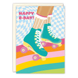 The Roller Skates Birthday Card by Lauren-Ashley Barnes features teal skates and white frilly socks, set against a colorful checkered blue background with rainbow stripes and “Happy B-Day!” in pink letters.