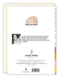 The back of the Roller Skates Birthday Card by Lauren-Ashley Barnes features a small black-and-white photo of her, a brief bio about her and her brand, and blooming colorful patterns illustrated along the card’s edge.