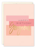 The Gorgeous Birthday Card by Amy Slaughter features pink and peach rectangles with gold and black Happy Birthday Gorgeous text. Printed on recycled paper, it includes an envelope thats partially visible behind the card.