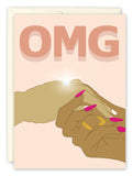 The Omg Engagement Card by Amy Slaughter features two brown-skinned hands—one with long pink nails giving a sparkling diamond ring—on recycled paper. Bold OMG text above celebrates this new journey together.