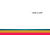 The Extra Ordinary Wedding Card by Andrea Williams features Congratulations on your union! in black at the top right, with bold teal, yellow, orange, and pink stripes at the bottom.
