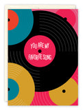 The Favorite Song Love Card by Andrea Williams features vinyl record illustrations on recycled paper. The largest black record with a pink center reads, You are my favorite song, with colorful inside details for a bright touch.