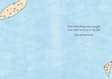 Introducing the Flowers Friendship Card by Cherrymae Golston, showcasing a light blue design with two decorative corner patterns adorned with colorful dots. Crafted from recycled paper, it includes the heartfelt message: "Your friendship has brought love, light, and joy to my life. You are the best.