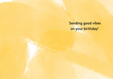 Stripes Happy Birthday Card by Lauren-Ashley Barnes features an abstract yellow watercolor background on recycled paper with Sending good vibes on your birthday! in black on the right, creating a cheerful illustrated card.