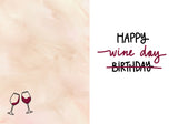 The Wine Aisle Birthday Card by Natalie Henry Charles features two wine glasses, Happy ~Birthday~ Wine Day (with Birthday crossed out), and is printed on light beige recycled paper.