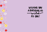 The Floral Beautiful Birthday Card by Natalie Henry Charles features colorful flowers on a light purple, recycled paper design with bold black handwriting: “Wishing you a birthday as wild as you!”.