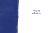 The No Words Sympathy Card by Tiffany Grimes features a white background with a bold, illustrated dark blue stripe on the left and blue text on the right: Just know you’re in my thoughts. Printed on high-quality recycled paper.