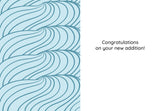 Celebrate eco-friendly style with the Nice Nice New Baby Card by Tiffany Grimes—crafted from recycled paper, it features a wavy blue pattern on the left and “Congratulations on your new addition!” in black text on white.