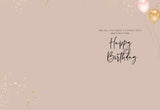 The Heels & Friends Birthday Card by Black Joy Paper features a beige recycled background, gold and pink balloons, gold splatter accents, and elegant text: All you need to strut into another year. Happy Birthday.