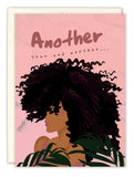 The Another Year Birthday Card by Tiffany McGraw features a woman with voluminous curly hair amid tropical leaves on a pink background and includes handwritten text: “Another year and another...” — perfect for birthday greetings.
