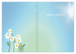 The Wonderful Birthday Card by Lauren-Ashley Barnes features a colorful illustration of white daisies with yellow centers on a blue-green gradient, sunlight in the top right, and Keep on blooming. written in white.