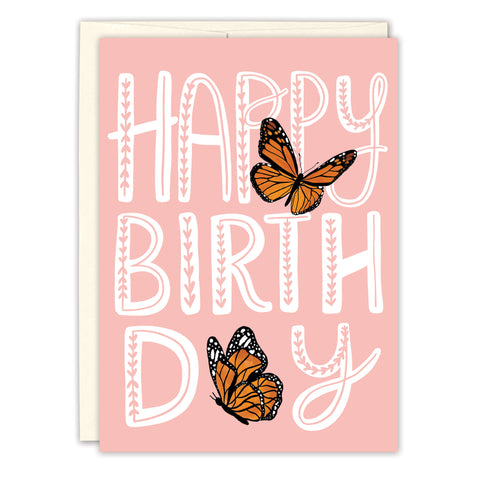 The Butterflies Birthday Card by Lauren-Ashley Barnes features a pink design with bold white Happy Birthday text and two orange monarch butterflies, one on Happy and one on Day. Includes an envelope—perfect for celebrating another year.